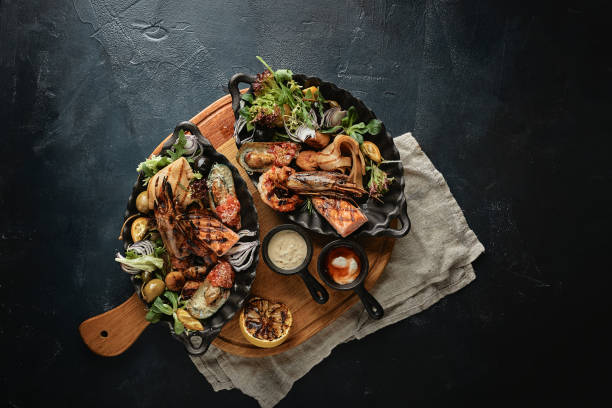 istock Assorted seafood, shrimp, scallops, squid, mussels. Serving plates on the table with a set of seafood. Classic italian food 1224898514