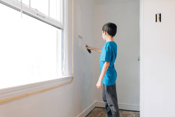 istock Little boy painting bedroom 1224900404