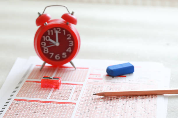 istock Answer sheet with pencil and alarm clock 1224900531