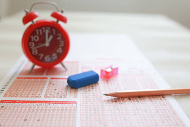 istock Answer sheet with pencil and alarm clock 1224900600