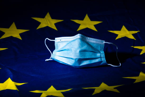 face mask on a European flag wrinkled face mask on a European flag illustrating a concept of health business capital region photos stock pictures, royalty-free photos & images