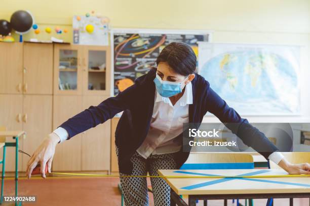 Covid19 The Teacher Marks Empty Places In The Classroom Stock Photo - Download Image Now