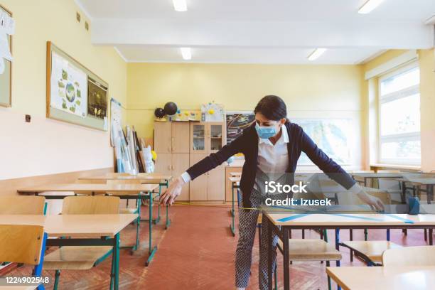 Covid19 The Teacher Marks Empty Places In The Classroom Stock Photo - Download Image Now