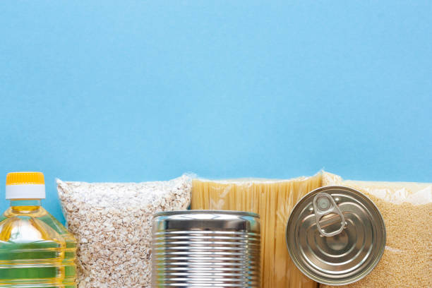 set of grocery items on blue - food donation box groceries canned food imagens e fotografias de stock