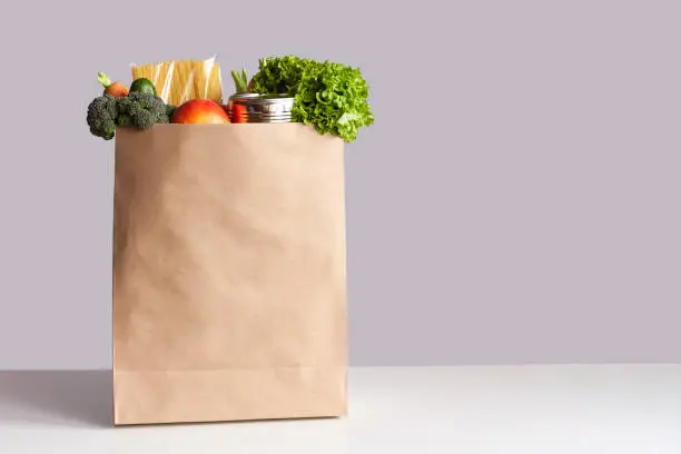 Photo of Paper bag with food gray background