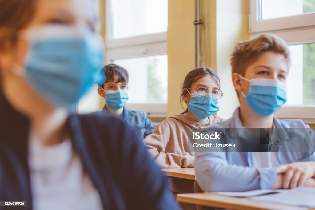 High school students at school, wearing N95 Face masks. High school students at school, wearing N95 Face masks.
Sitting in a classroom. Education Stock Photo
