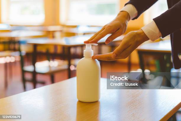 Using Hand Sanitizer In The Classroom Stock Photo - Download Image Now - Avoidance, Back to School, Blue