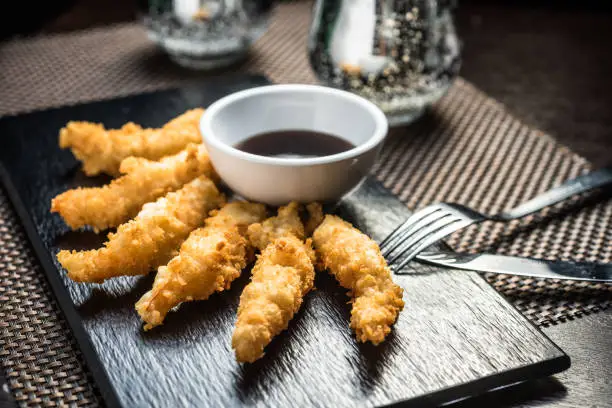 Chicken fillet pieces in tempura dough with sweet and sour sauce