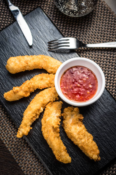 istock Chicken fillet pieces in tempura dough with sauce 1224920873
