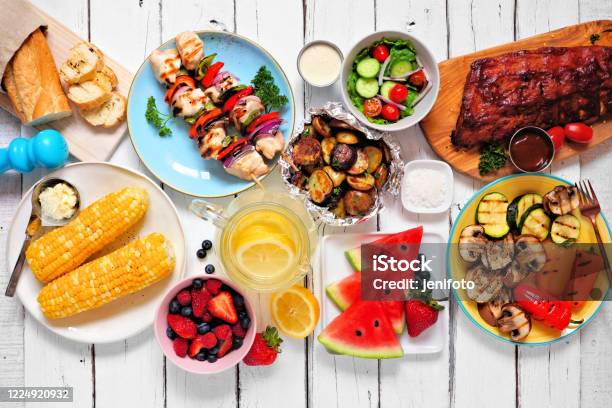 Summer Bbq Or Picnic Food Top Down View Table Scene Over White Wood Stock Photo - Download Image Now