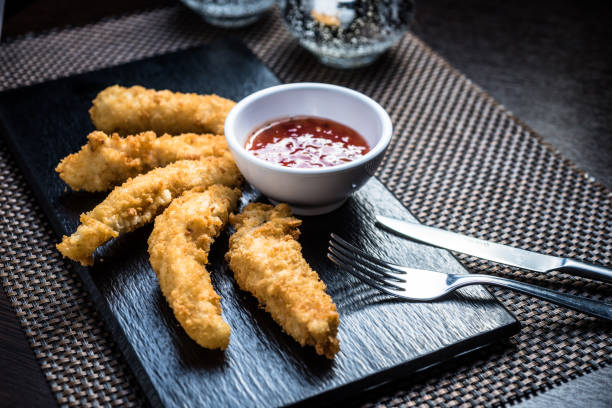 istock Chicken fillet pieces in tempura dough with sauce 1224921699
