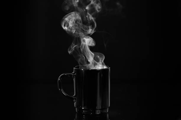 istock Steam rising from a cup hot tea in black mug 1224922603