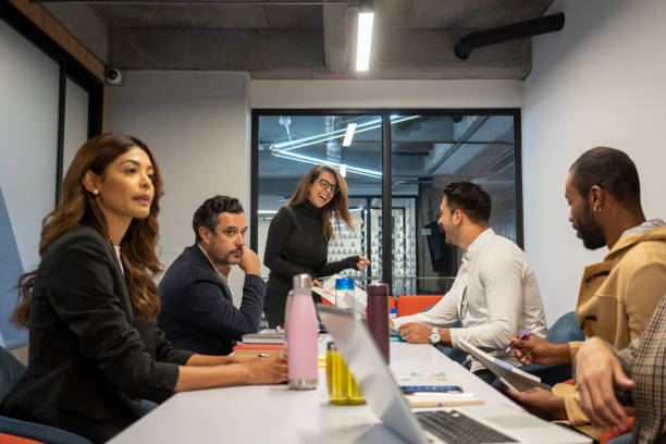 istock Latina female boss explains company issues at employee meeting 1224923519