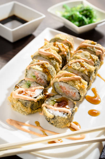 istock SAKE AVOKADO TEMPURA hot sushi rolls with salmon 1224923686