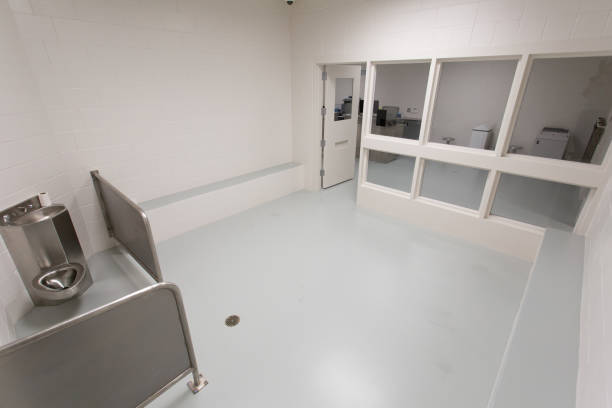 Inside modern jail cell with single latrine. stock photo