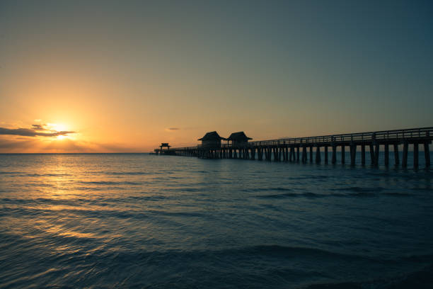 istock naples Pier at sunset with copy space 1224923715