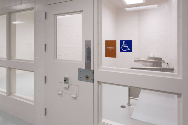 Close up of locked door in a modern jail holding cell stock photo