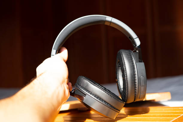 istock Hands picking up music headphones. 1224923834