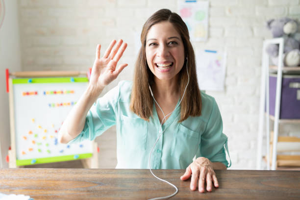 Screenshot of a teacher waving hello