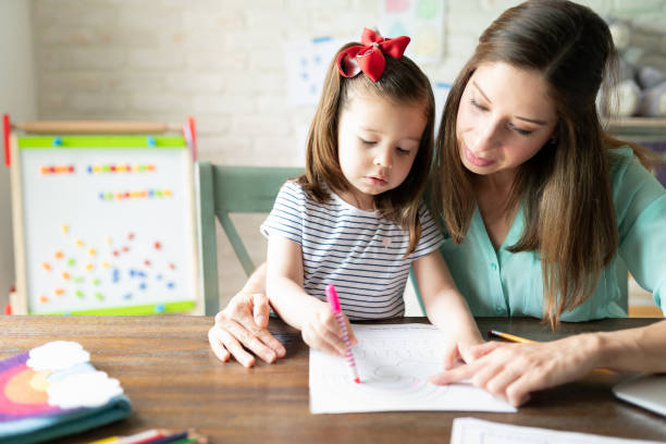 istock Mom helping daughter with school 1224925099