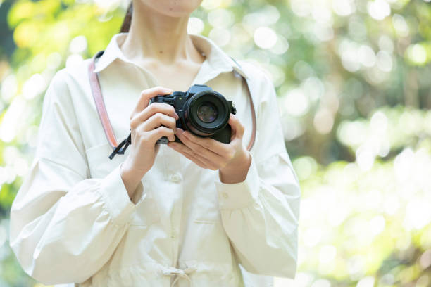 Young woman holding a camera in nature