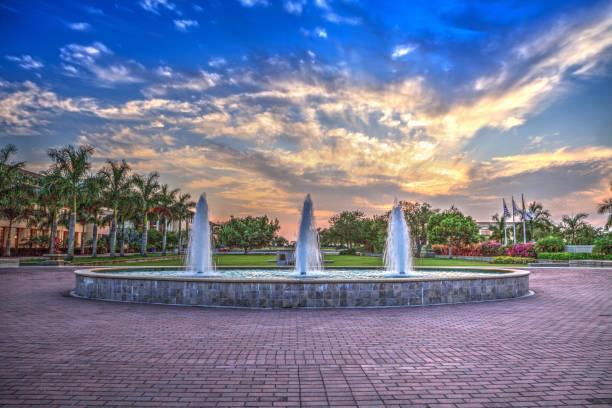 istock Sunset over a fountain with three sprays in a reflective pool 1224931677