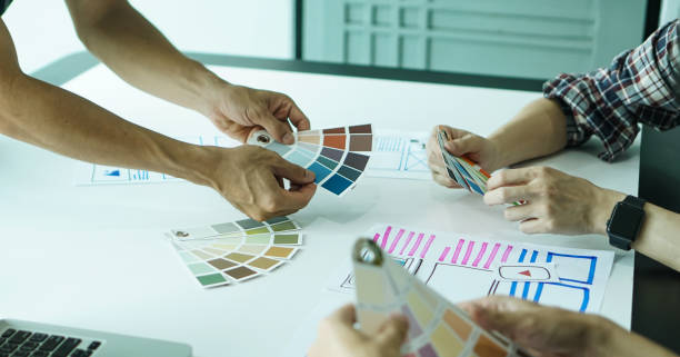 istock Designers man drawing ui/ux designers working and designing user interface for website and application, working together with partner planning and brainstorming sketch designs with computer laptop. 1224932688
