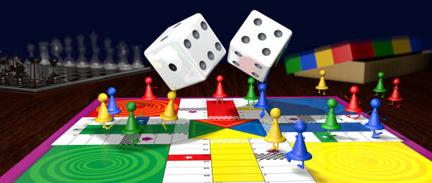 istock Red, blue, yellow and green board game chips walking on the board, while two chips throw the dice in the middle of the game at the bottom of the table there is a chess and a box. 3D Illustration 1224937392