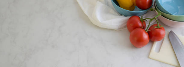 istock Overhead shot of marble kitchen table with kitchenware, vegetable, dish towel and copy space 1224942244
