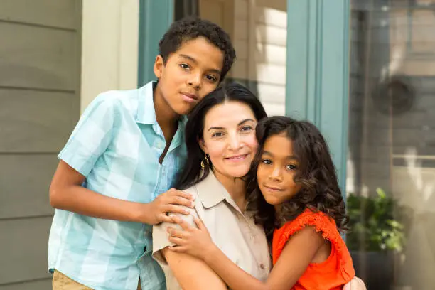 Photo of Hispnaic mother laughing and talking with her children.