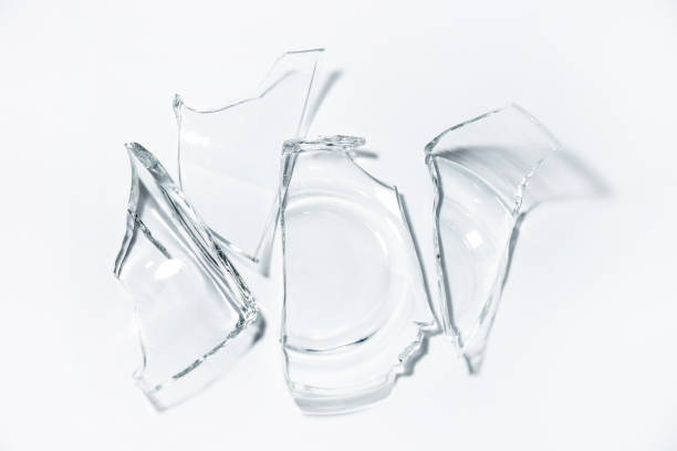 Parts of the broken cup jar glass isolated on white background stock photo