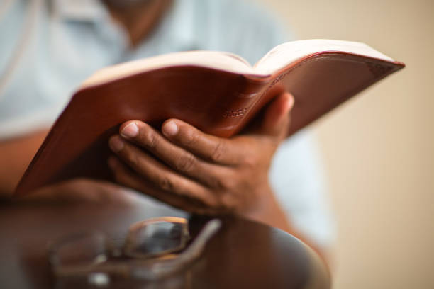 istock African American man praying and reading the Bible. 1224944814