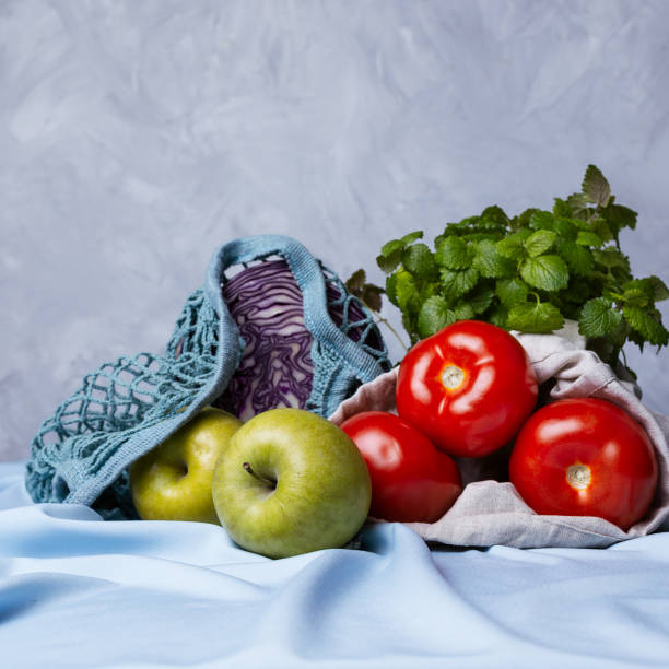 istock Apples, tomatoes, fresh herbs and red cabbage in zero waste bags 1224945786