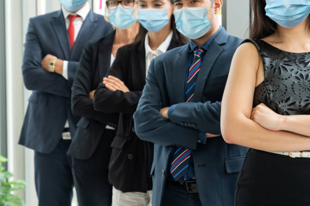istock Confident business people with face mask protect from Coronavirus or COVID-19. 1224945799