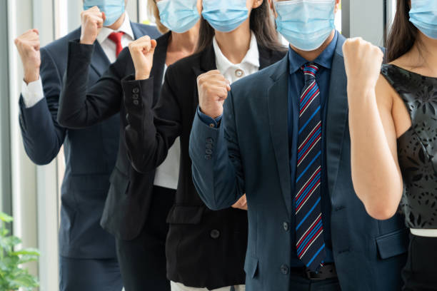 istock Confident business people with face mask protect from Coronavirus or COVID-19. 1224945829