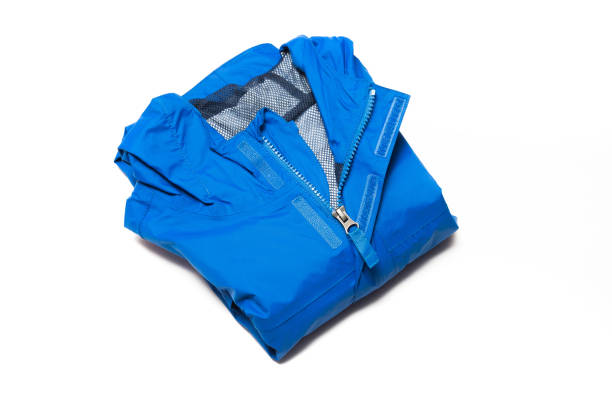 Folded blue zipper windbreaker jacket, rain proof and waterproof hiking Gore-Tex jacket hoodie. Track jacket sport nylon full zip stock photo