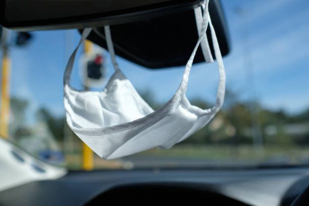 istock Face mask hanging from a vehicle rear view mirror 1224946986