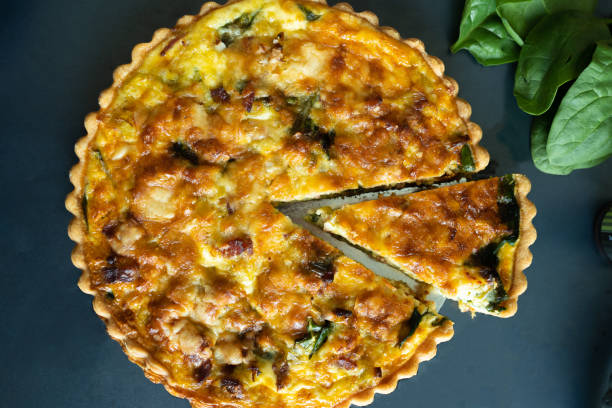 istock top view freshly bake leek bacon spinach quiche on dark background 1224947781