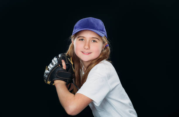 istock A smiling nine years old girl is throwing a baseball. 1224948883