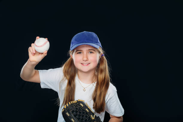 istock A smiling nine years old girl is throwing a baseball. 1224948985