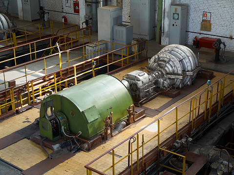 A bank of seven generators inside a hydro-electric dam.