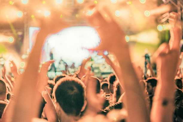 istock cheering crowd at rock concert 1224951279