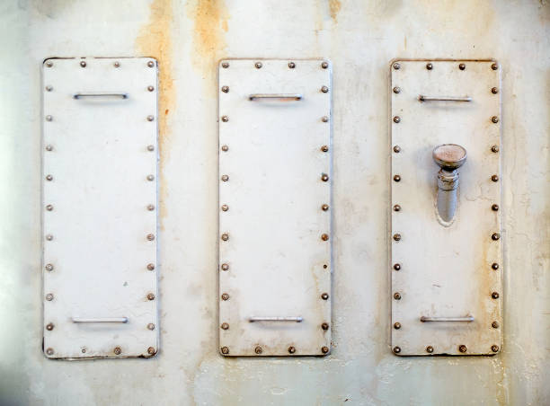 istock Three metal hatches plate on compressor for revision close-up with oiler neck painted with gray paint bolted with studs and nuts background copy space. 1224951351