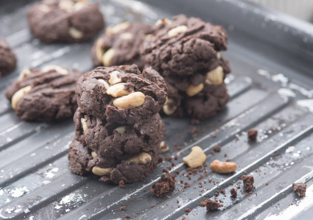 istock Delicious chocolate cookies with nuts on a baking tray 1224951377