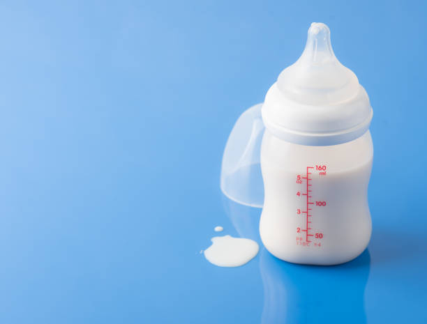 istock Baby milk bottle on a blue background 1224951497