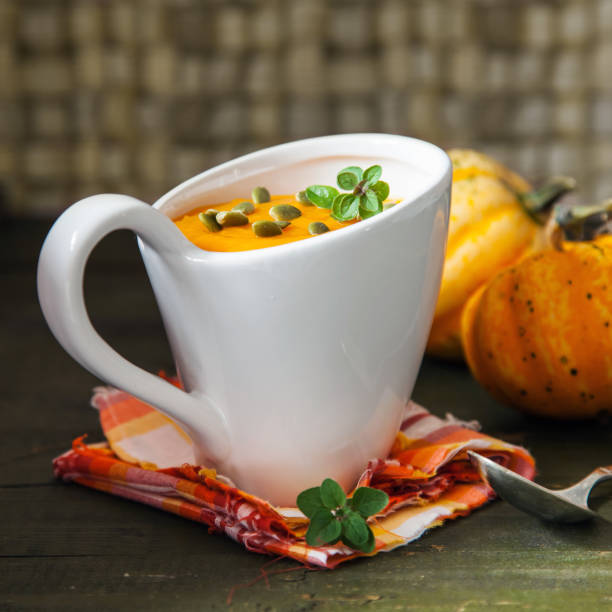 istock pumpkin cream soup in a cup on a table, selective focus, copy space 1224951552