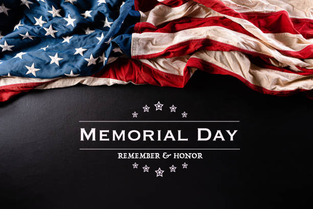 istock Happy Memorial Day. American flags with the text REMEMBER & HONOR against a black  background. May 25. 1224953143
