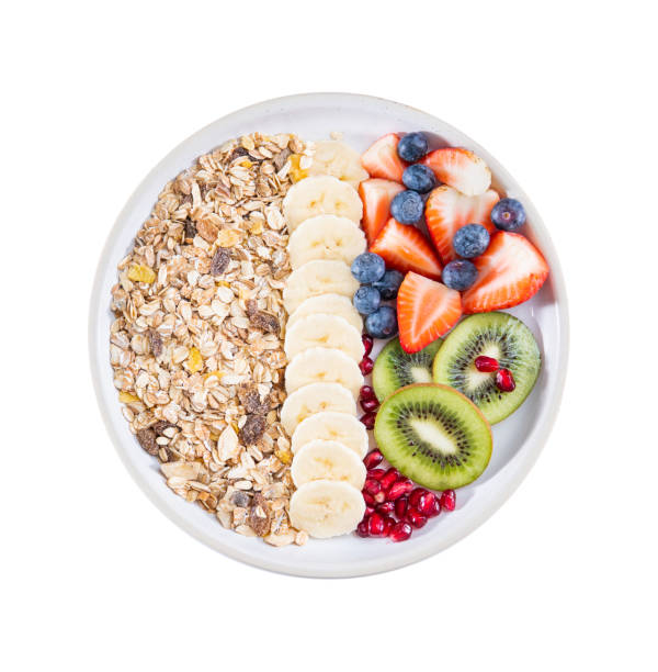 Delicious healthy breakfast of fruit salad with oat muesli. Dietary breakfast stock photo