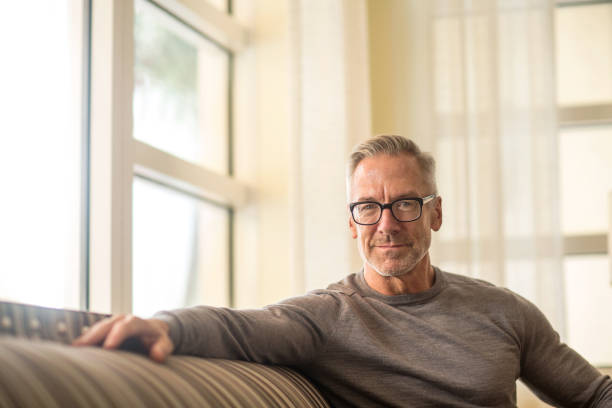 istock Portarit of a handsome older man sitting on a sofa. 1224956105