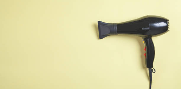 istock Hair dryer on the yellow background. 1224961080